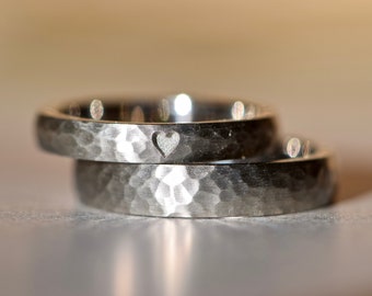 Wedding rings hammered platinum with heart symbol