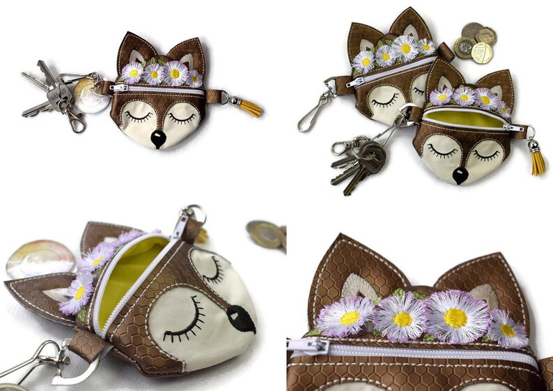 Pu&ograve; includere: Portamonete a forma di volpe marrone e crema con decorazioni floreali a margherita. I portamonete hanno una chiusura a cerniera e un nappa gialla. Chiavi e monete sono mostrate con i portamonete. I portamonete sono realizzati in un materiale strutturato.
