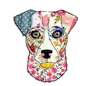 May include: A colourful patchwork fabric dog head with floral patterns, polka dots, and a pink and white checked pattern. The dog has black eyes and a black nose.