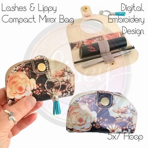 May include: A floral patterned compact mirror bag with a small mirror, a key ring, and a tassel. The bag is open to reveal a lipstick, a pair of tweezers, and an eyebrow brush. The text "Digital Embroidery Design" and "5x7 Hoop" are visible.