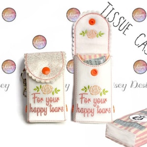 May include: Two white felt tissue cases with pink and orange embroidery. The cases have a flap that opens to reveal a pocket for tissues. The embroidery says "For your happy tears".