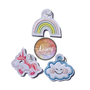 May include: Set of three embroidered iron-on patches featuring a rainbow, a cloud with a smiley face, and a unicorn. The patches are designed for use on clothing, bags, or other fabric items.  The patches are white with colorful embroidery.