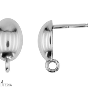 Pode incluir: Um par de brincos de botão ovais prateados. Cada brinco tem um pino para perfurar e um pequeno laço na parte inferior. Os brincos são exibidos em um fundo branco.