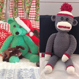 May include: Two crocheted stuffed toys, a green bear wearing a red Santa hat and a gray monkey wearing a red and white striped hat with a red pom-pom.