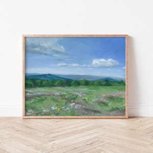May include: A painting of a landscape with a field of wildflowers in the foreground, a line of trees in the middle ground, and a mountain range in the background. The sky is blue with white clouds.