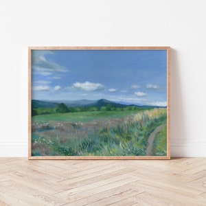 May include: A painting of a green grassy field with a dirt path leading to a mountain range in the distance. The sky is blue with white clouds.