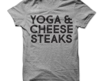 May include: Gray t-shirt with the text "Yoga & Cheese Steaks" printed in black.
