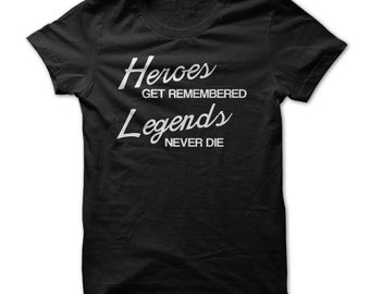 May include: Black t-shirt with white text that reads "Heroes get remembered Legends never die."