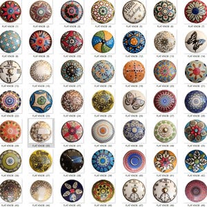 May include: A collection of flat knobs with various decorative designs. The knobs feature floral, geometric, and butterfly patterns in a range of colors, including blue, red, orange, and white. Some knobs have clock faces or text.