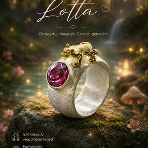 May include: A silver ring featuring a textured band, a gold-toned frog figure, and a round, faceted magenta crystal. The text "Frosch Lotta", "Einzigartig. Verspielt. F&uuml;r dich gemacht.", "925 Silber & vergoldeter Frosch", "Funkelnder Kristallstein", "Mit Liebe handgefertigt", and "Eigen-Schmied Design" is visible.