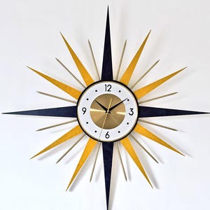 Reloj de pared Starburst de mediados de siglo: diseño atómico en negro y dorado