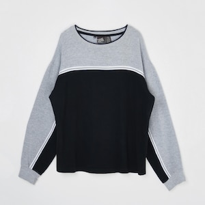 May include: A gray, black, and white color block sweatshirt. The top and sleeves are gray, with a black center panel. White stripes accent the chest and sleeves. The sweatshirt has a crew neck and a tag that reads "CVS".