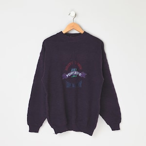 May include: A dark purple sweater with a colorful embroidered logo that says "POINTZERO" and "NOWHERE IS FAR AWAY".