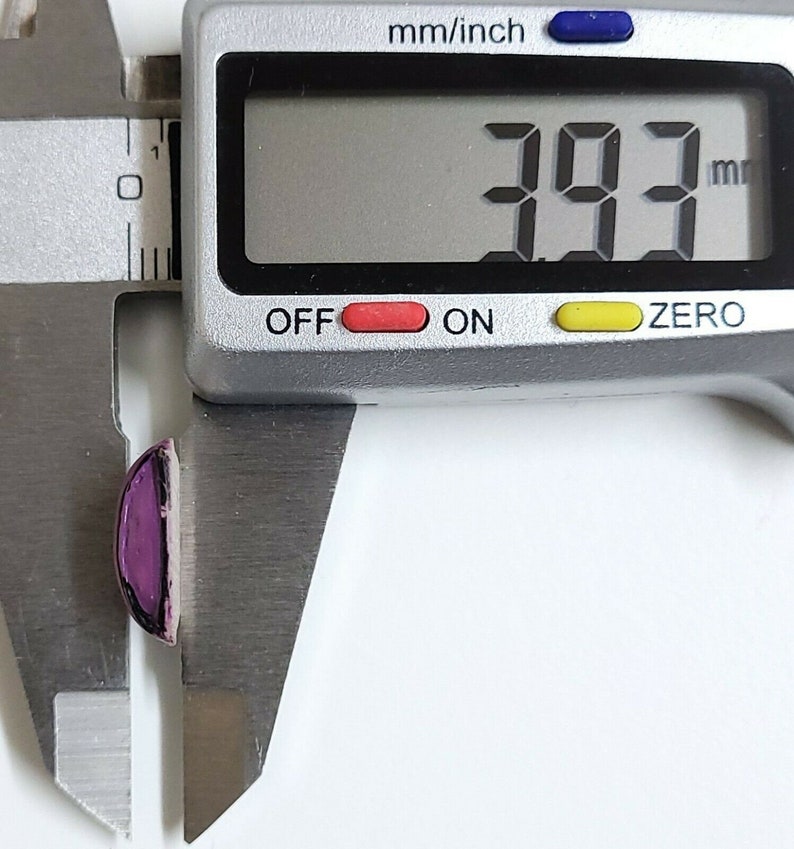 May include: A close-up of a digital caliper measuring a purple and silver object. The reading on the caliper is 39.3 mm.