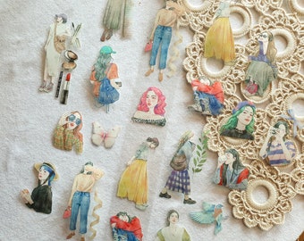 May include: Watercolor stickers featuring fashion illustrations of women in various poses and outfits. The stickers include images of women wearing jeans, skirts, and dresses, with accessories like sunglasses, hats, and bags. A butterfly sticker is also included.