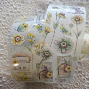 May include: Decorative washi tape roll featuring watercolor illustrations of butterflies, flowers, and vintage ephemera. The tape has a light background with a repeating pattern of yellow, green, and blue elements. The text "Dear" is visible.