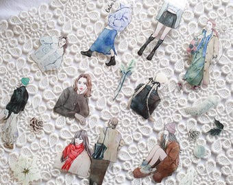 May include: A collection of colorful illustrations of people wearing winter clothing. The illustrations are printed on white paper and are perfect for scrapbooking or card making.