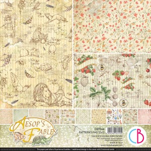 Könnte beinhalten: Ein gemustertes Papierpad mit verschiedenen Designs. Der obere Bereich zeigt Illustrationen von Äsops Fabeln, darunter Tiere und Text. Weitere Designs umfassen Blumen- und Erdbeermuster. Das Pad enthält 15 Muster und Unifarben.
