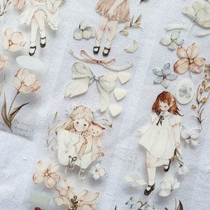 Peut inclure: Ruban adh&eacute;sif d&eacute;coratif avec des illustrations &agrave; l'aquarelle de filles, de fleurs et de n&oelig;uds dans des tons pastel. Le ruban comprend des fragments de texte et est id&eacute;al pour le scrapbooking et les projets de bricolage.