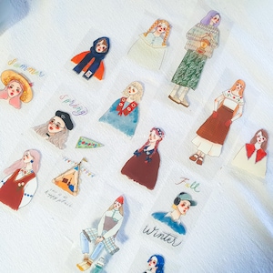 May include: A set of 11 clear stickers featuring illustrations of people in various outfits and poses. The stickers are labeled with the words "Summer", "Spring", "Fall", and "Winter".