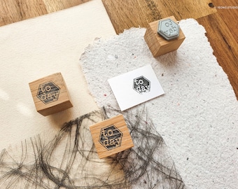 May include: Three wooden stamps with the word "to day" printed on them. The stamps are in a hexagonal shape and are on a white surface.
