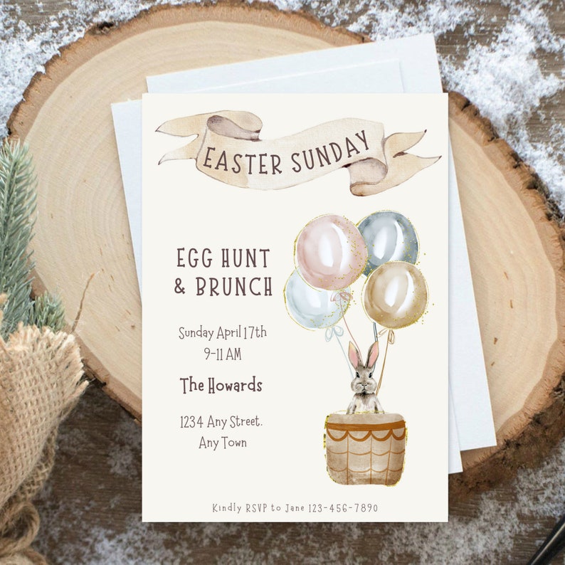 May include: An invitation to an Easter Sunday egg hunt and brunch. The invitation features a watercolor illustration of a bunny in a hot air balloon with pastel colored balloons. The text reads "Easter Sunday", "Egg Hunt & Brunch", "Sunday April 17th 9-11 AM", "The Howards", "1234 Any Street. Any Town", and "Kindly RSVP to Jane 123-456-7890".