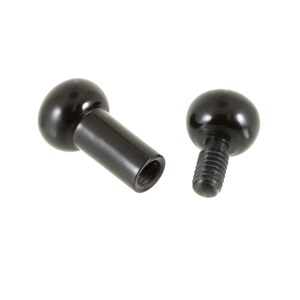 May include: Two black ball-shaped knobs with threaded stems. One knob has a smooth stem and the other has a threaded stem.