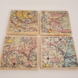 May include: Set of four square coasters featuring vintage maps of different regions. Each coaster has a beige background with brown, blue, red, and yellow markings. The maps include text such as "Nashville", "Tenasquille", "Hawkins", "Sheloyville", and "Rockymores".