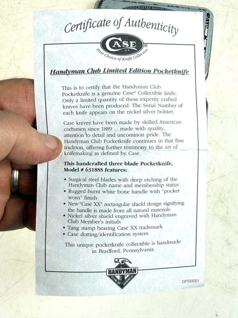 May include: A certificate of authenticity for a Handyman Club Limited Edition Pocketknife. The document details the knife's features, including surgical steel blades, a burnt white bone handle, and a nickel silver shield. The knife is handmade in Bradford, Pennsylvania.