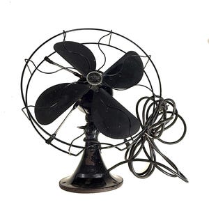 May include: A vintage black Emerson electric fan. The fan has four blades and a protective wire cage. The base is round and the fan is connected to a black power cord. The fan is a classic design.