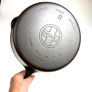 May include: A cast iron 9 inch Griswold skillet with the words "CAST IRON SKILLET" and "ERIE, PA. U.S.A. 728" on the bottom.
