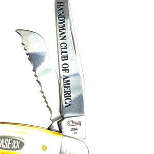 May include: A Case-XX USA pocket knife with a cream-colored handle and two blades. One blade is serrated, and the other is engraved with "Handyman Club of America." The knife is partially open, showcasing the blades.