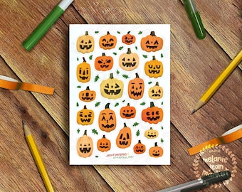 May include: A sheet of 20 Halloween stickers featuring orange and yellow jack-o'-lantern faces with different expressions. The stickers are on a white background with green leaves.