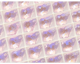 May include: A sheet of clear plastic packaging containing many small, iridescent, light purple, faceted crystal butterfly charms.