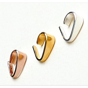 Puede incluir: Tres cierres de colgante de metal en oro, plata y oro rosa.