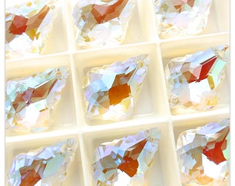 May include: A set of ten clear iridescent glass teardrop-shaped pendants with a faceted design. The pendants have a hole at the top for stringing.