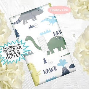 May include: White light switch cover with a dinosaur theme. The cover features a green dinosaur, a blue dinosaur, a yellow dinosaur, and a volcano with the word "RAWR" printed on it. The text "Shabby Chic" is printed in the top right corner.