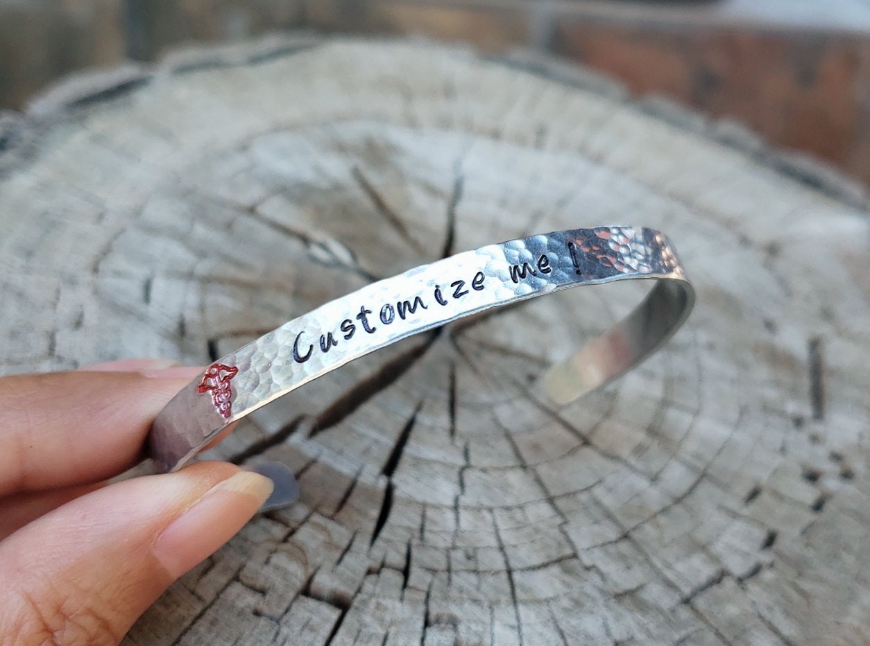 Handmade silver bangle with a simple exterior and lots of birthstones and  engravings on the inside | Example of handmade work