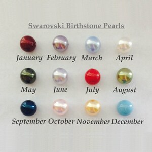 May include: Twelve Swarovski birthstone pearls in various colors, arranged in a grid. The pearls represent each month of the year, starting with January (red) and ending with December (light blue).