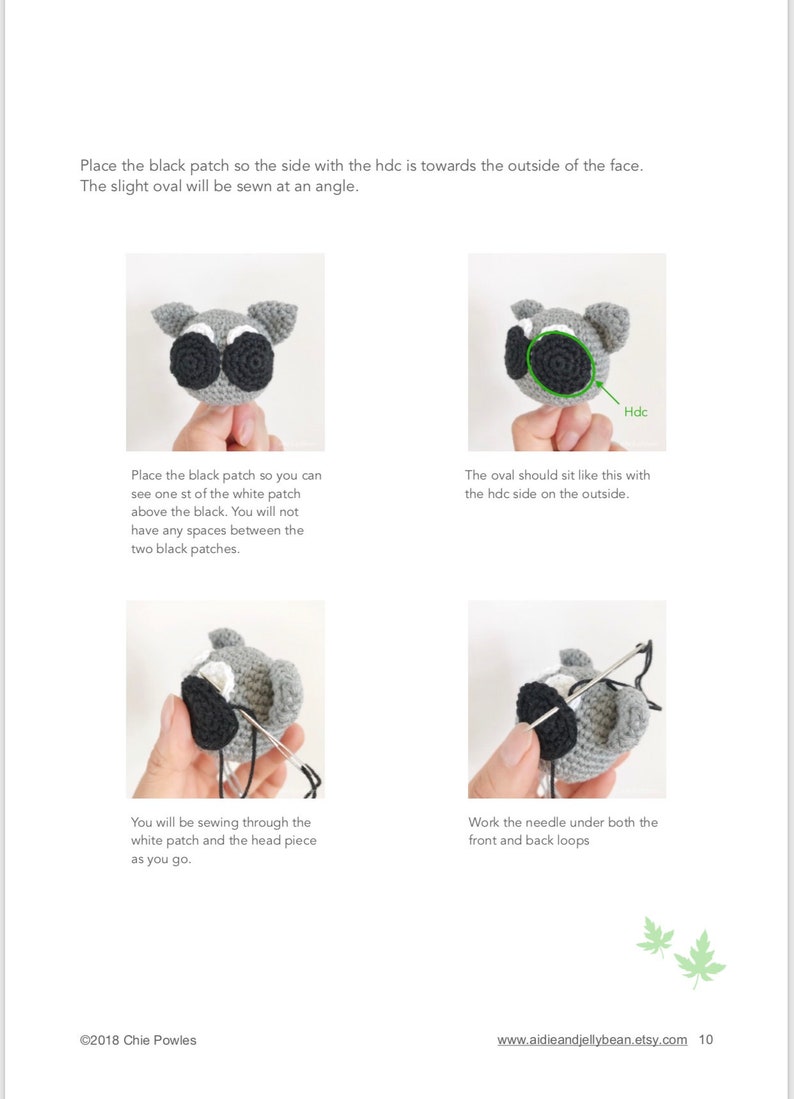 May include: A step-by-step guide on how to sew a black oval patch onto a crocheted raccoon head. The instructions show how to place the patch, sew it in place, and work the needle under both the front and back loops.