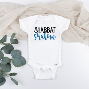 May include: White baby onesie with the text "Shabbat Shalom" in black and blue lettering.