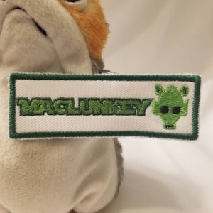May include: Green embroidered patch with the text "WAGUNSKY" and a green alien graphic.