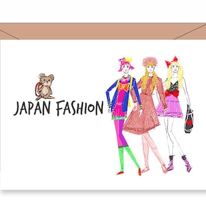 May include: A greeting card with a cartoon illustration of three women in colorful outfits and a teddy bear with a backpack. The text "JAPAN FASHION" is printed on the card.