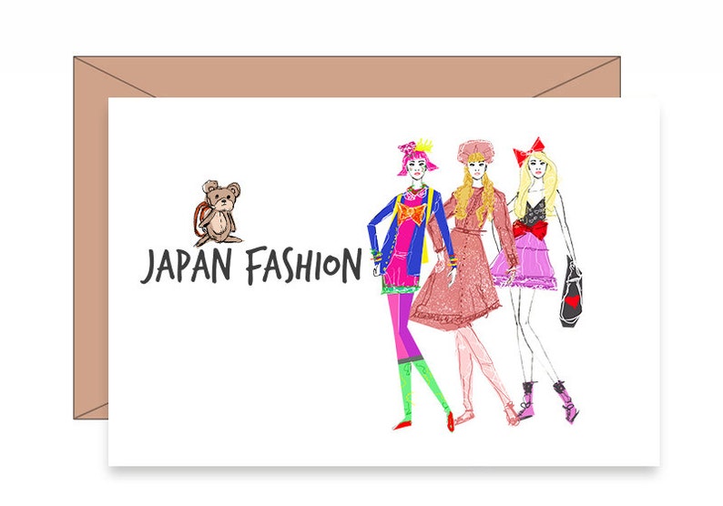 May include: A greeting card with a cartoon illustration of three women in colorful outfits and a teddy bear with a backpack. The text "JAPAN FASHION" is printed on the card.