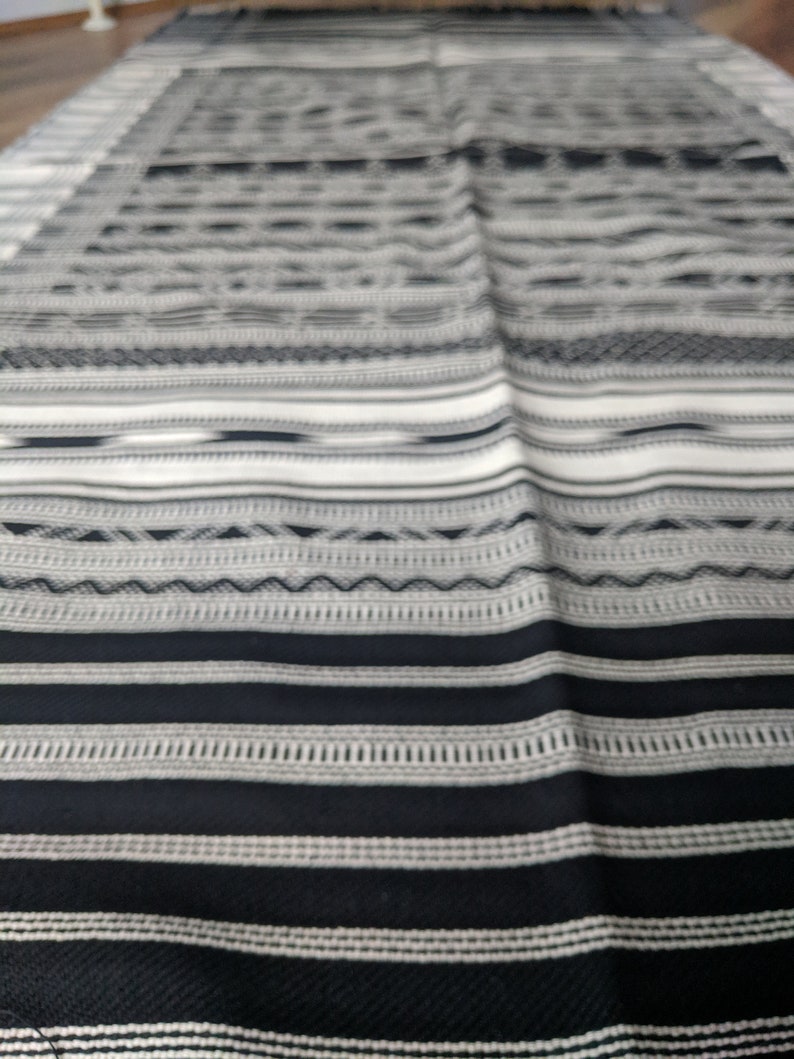 Black and white striped handwoven tribal design rug