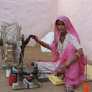 Indian artisan spinning thread in rural Rajasthan village