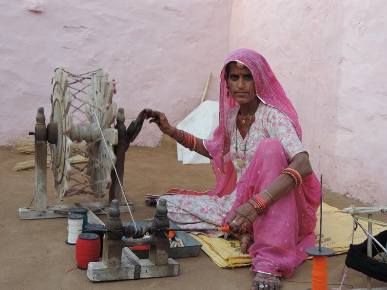 Indian artisan spinning thread in rural Rajasthan village
