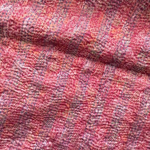 Close up detail of floral patterns on a upcycled sari silk scarf with hand embroidered Kantha running stitch to create a lightly quilted look.