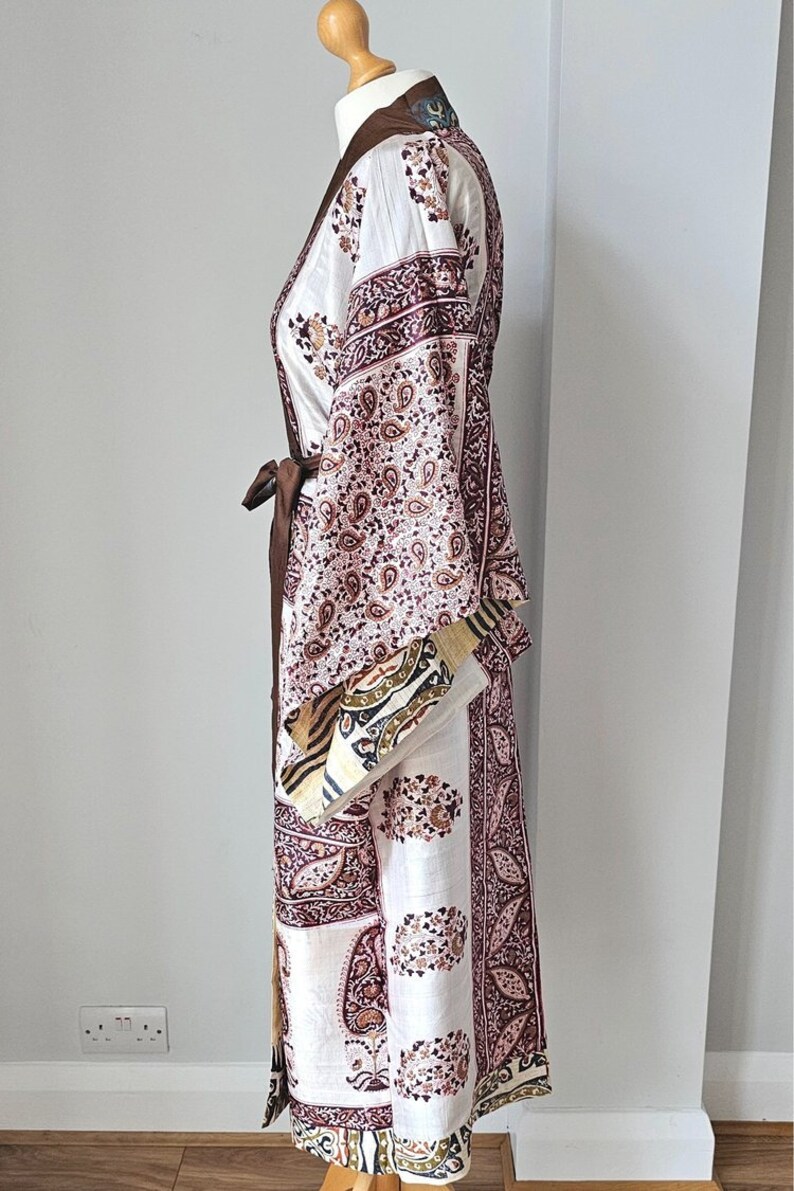 Full length side view of pretty recycled sari dressing gown with long kimono sleeves in paisley print.