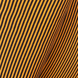 May include: Orange and black striped fabric with a diagonal pattern.